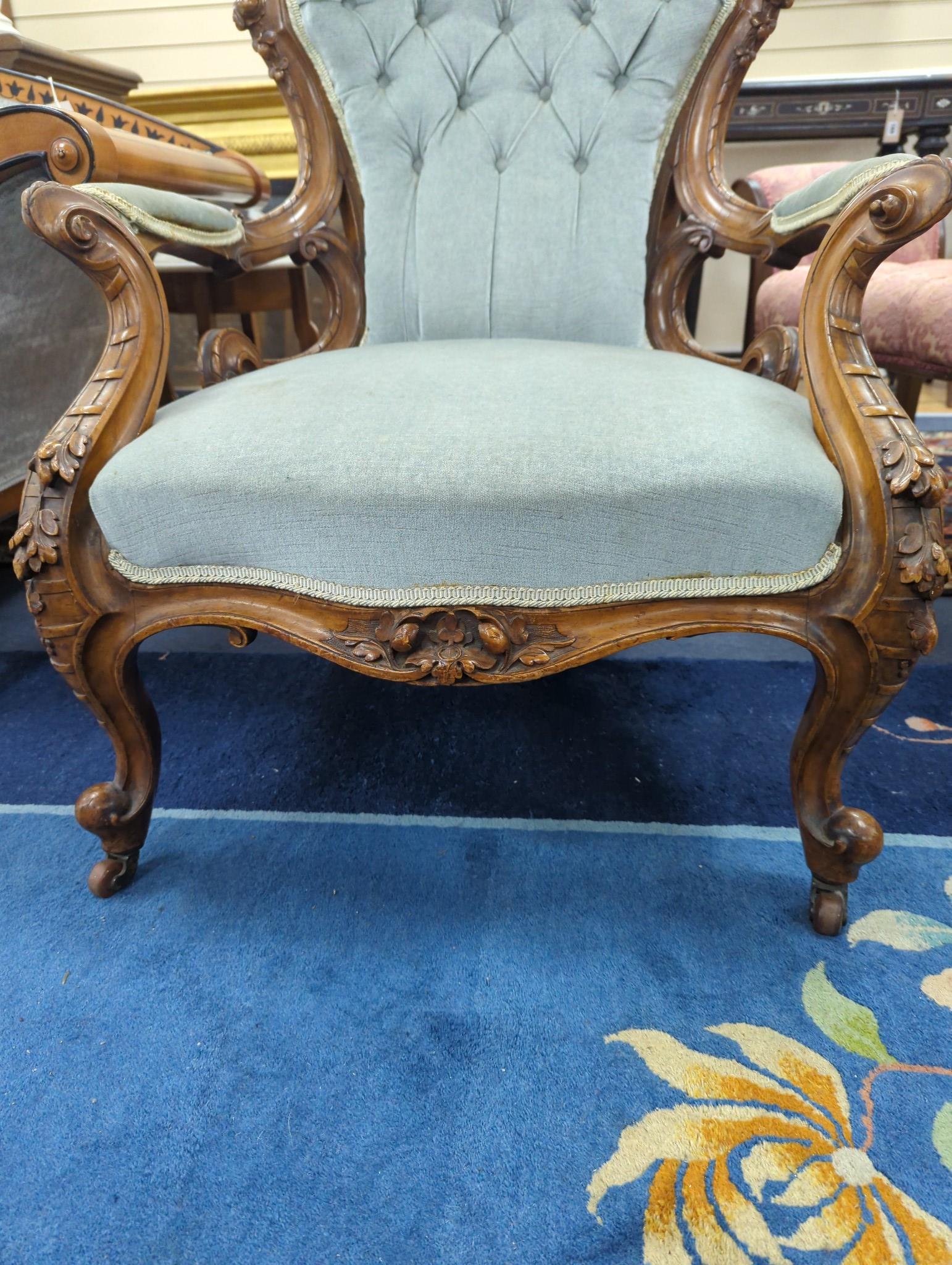 A Victorian carved walnut upholstered open armchair, width 68cm, depth 60cm, height 103cm